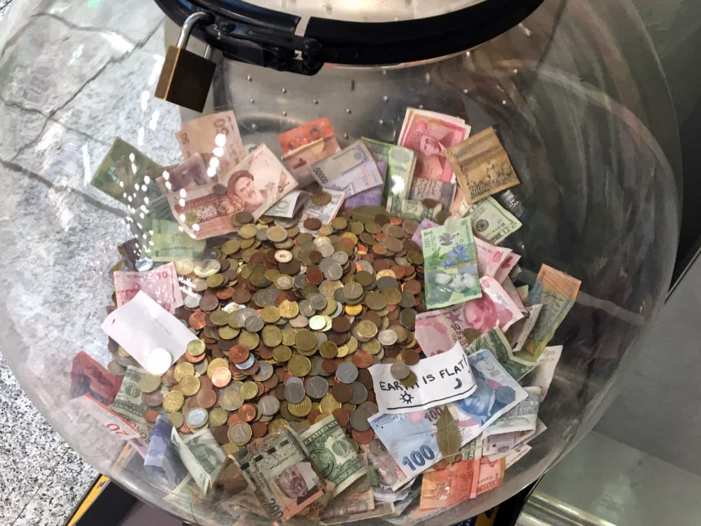 Charity donation box for leftover currency at the airport.