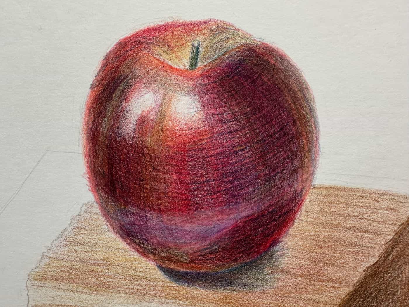 Pencil drawing of a red apple sitting on top of a wooden block.
