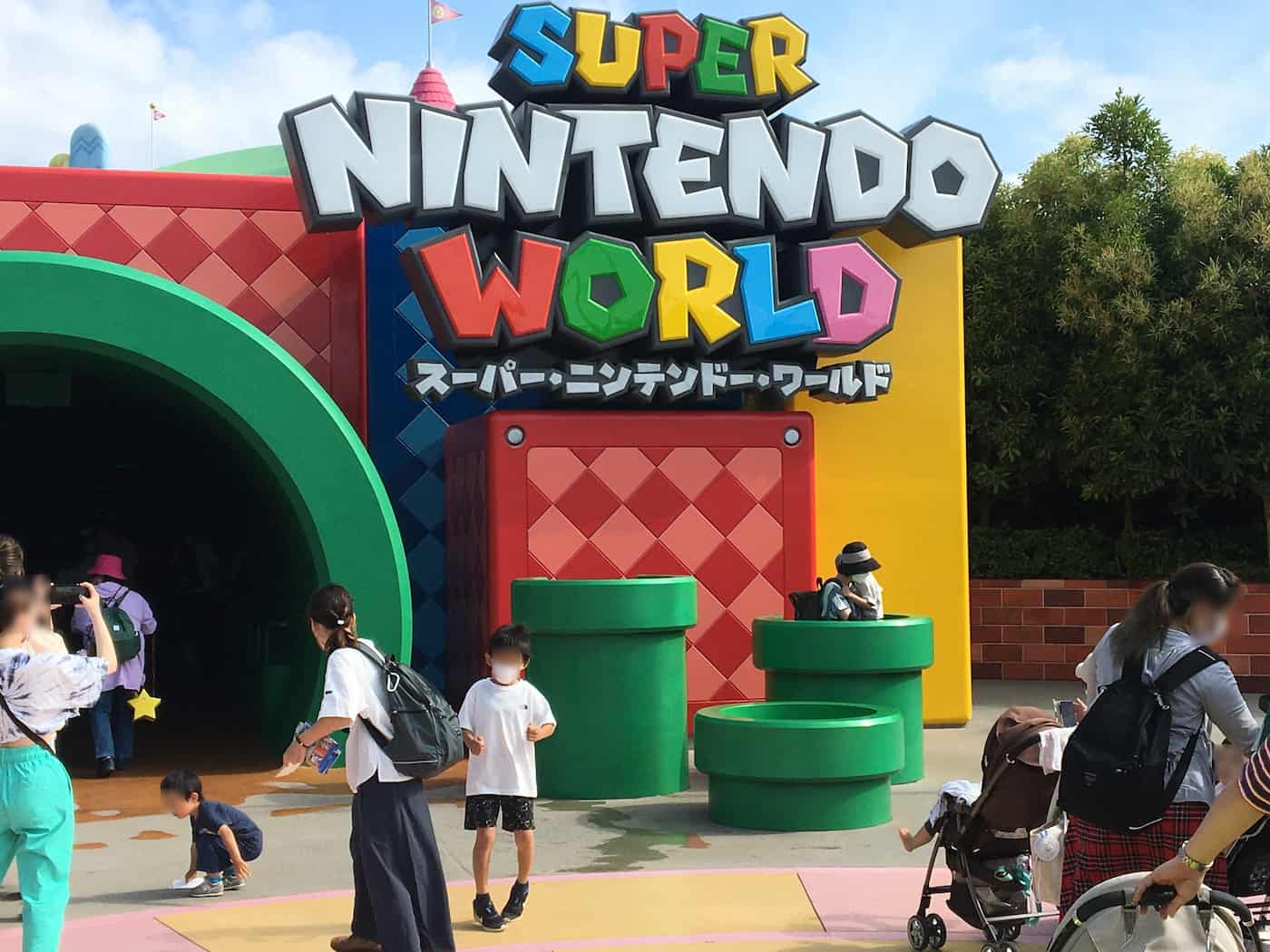 Vibrant and colorful entrance to Super Nintendo World at Universal Studios Japan, featuring iconic Super Mario-themed decorations and architecture.