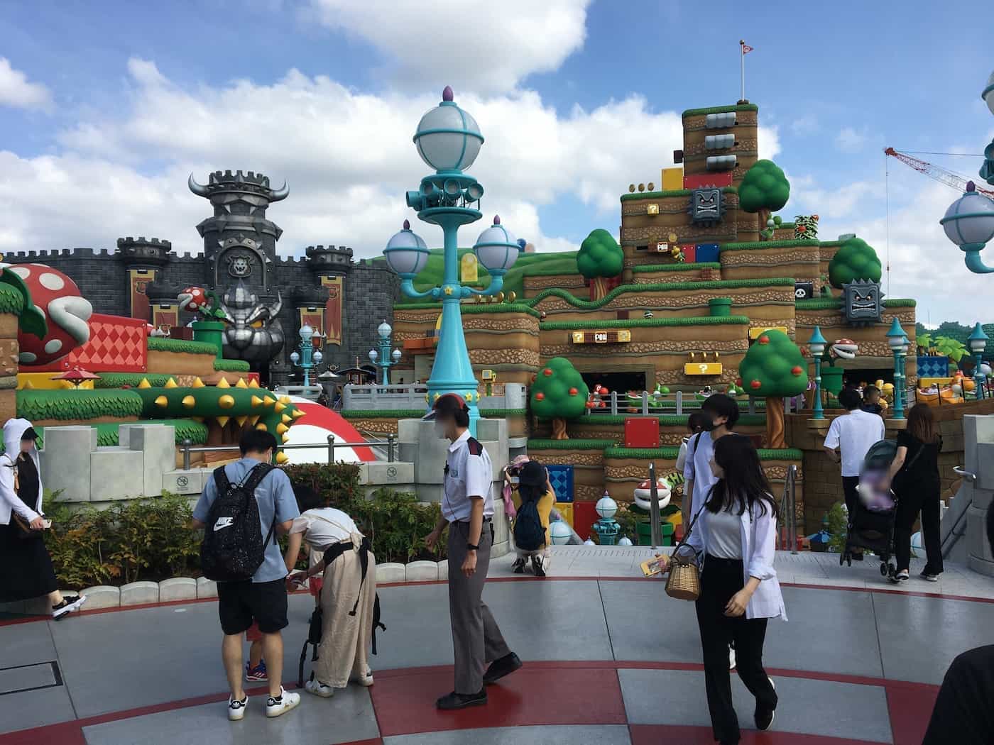 An imposing view of Bowser's Castle, standing prominently in the distance, at Super Nintendo World.