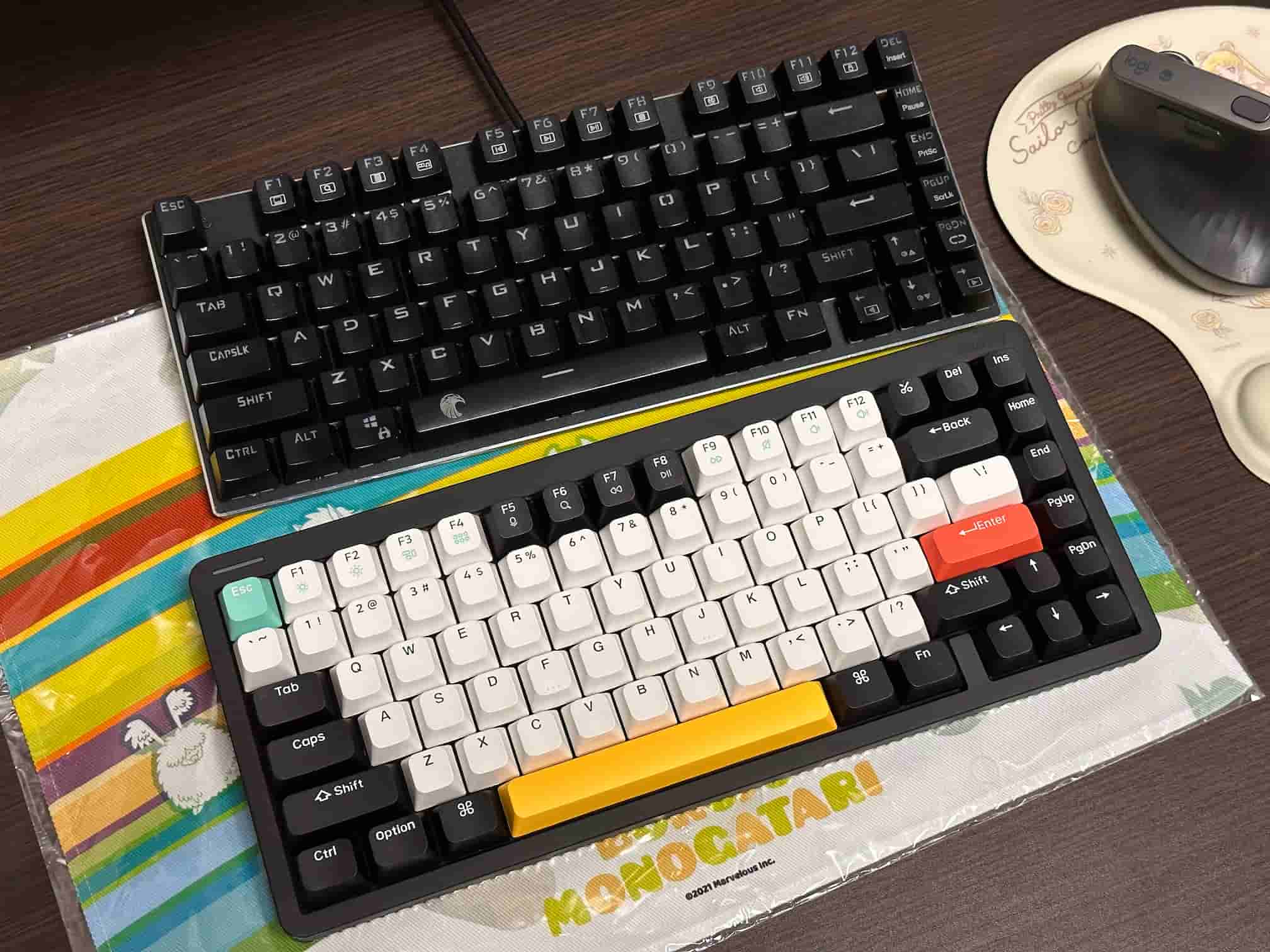 A side-by-side comparison of two mechanical keyboards, with the E-Yooso Z-88 on top featuring all black keycaps, and the NuPhy Halo75 on the bottom with white, black, gray, and colorful keycaps including a standout red Enter key