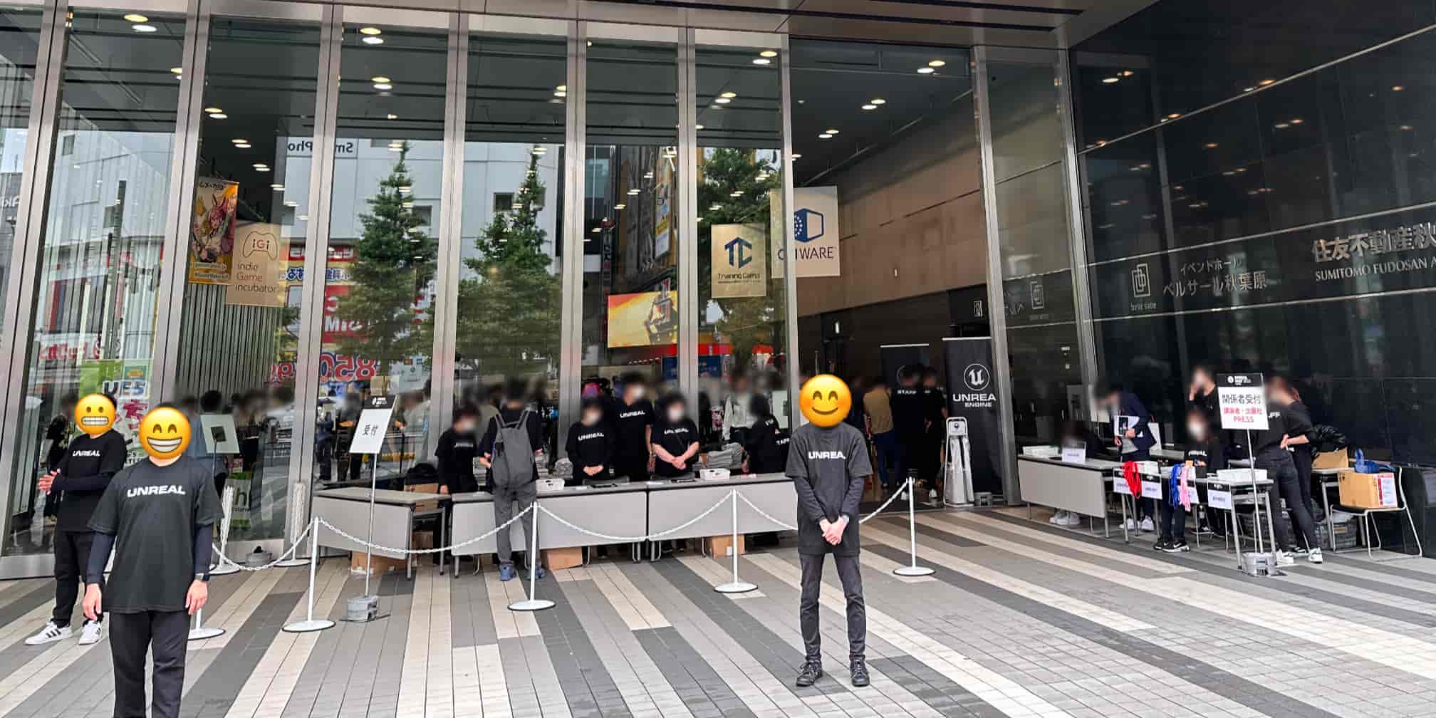Entrance of Bellesalle Akihabara during Unreal Fest Tokyo 2023, with attendees in Unreal Engine shirts registering at event tables