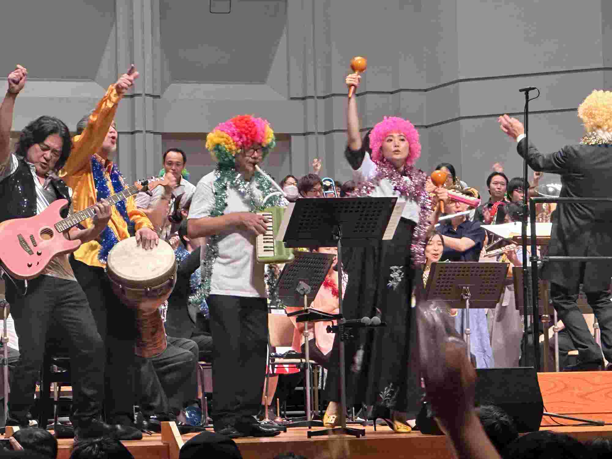 Nobuo Uematsu and other musicians performing enthusiastically during the final song at the BRA★BRA FINAL FANTASY 2024 concert, with colorful wigs and instruments